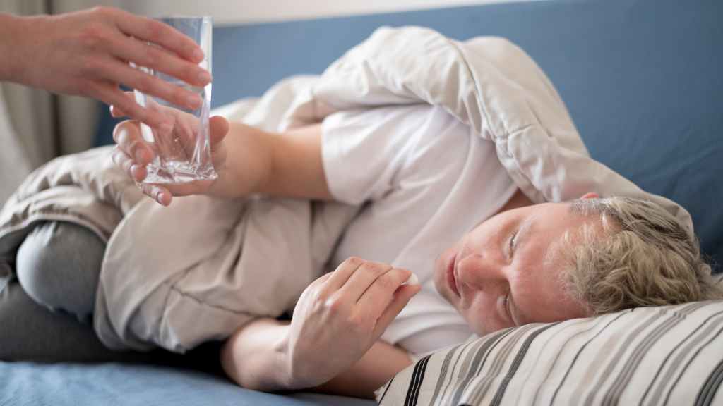 sick person receiving glass water 1