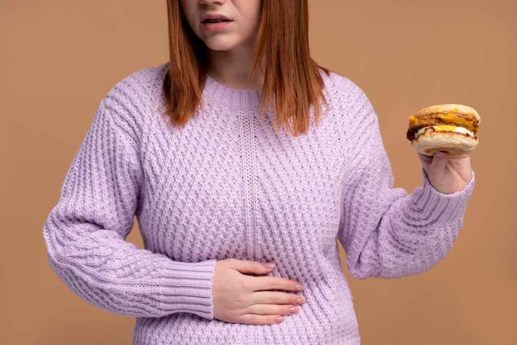 woman with eating disorder trying eat burger 1