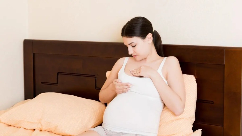 pregnant-woman-checking-breast-changes-self-exam-at-home