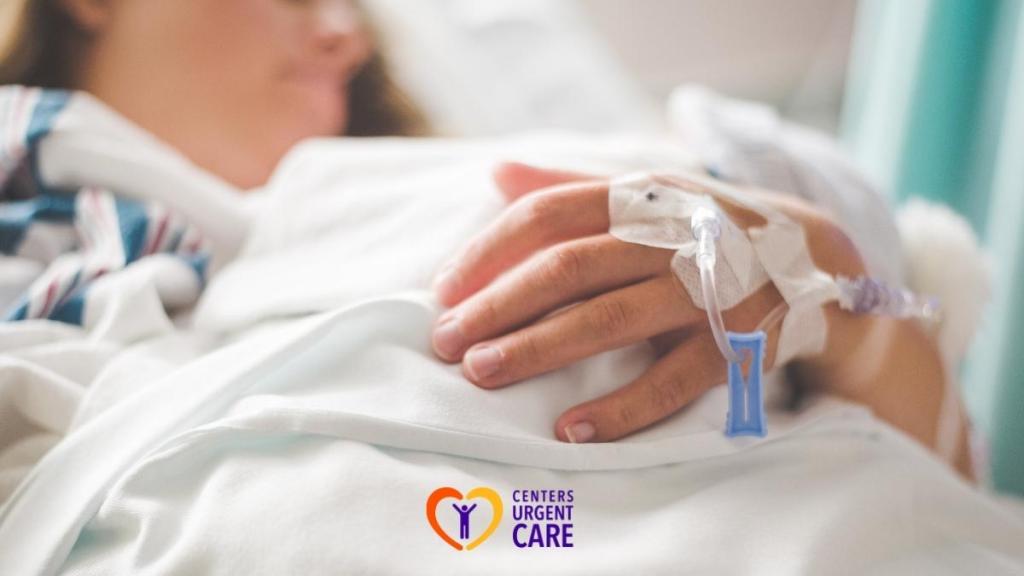 patient hand with iv line in hospital bed