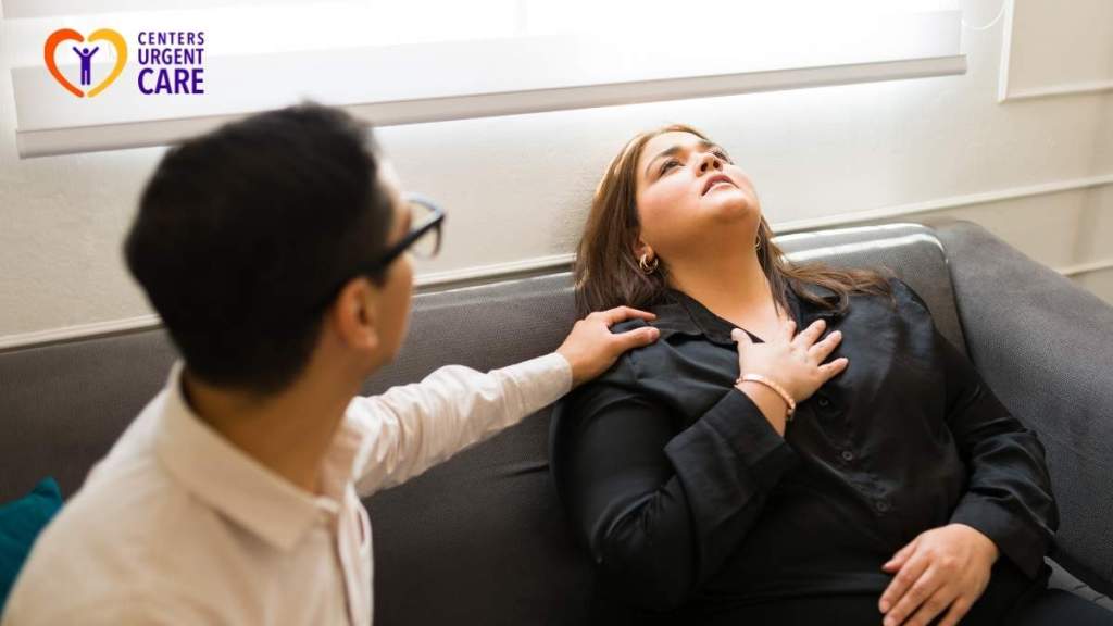 woman-holding-chest-while-seated-on-couch