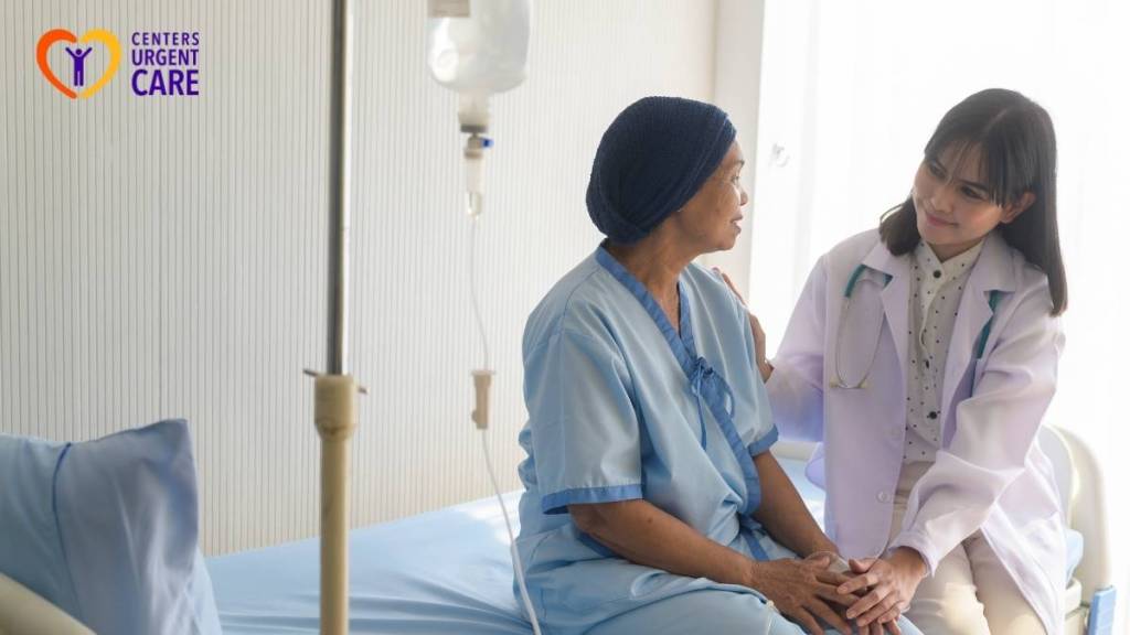 Doctor comforting an elderly patient seated on a clinic exam bed